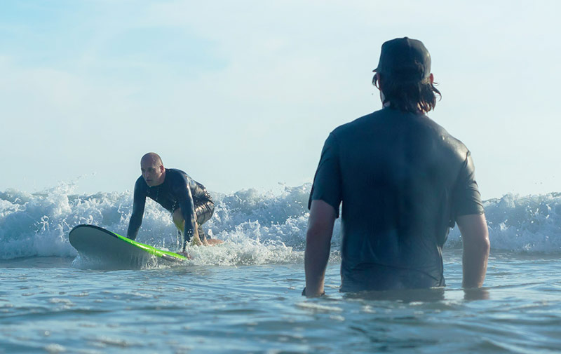 Surf coaching water lesson catching wave